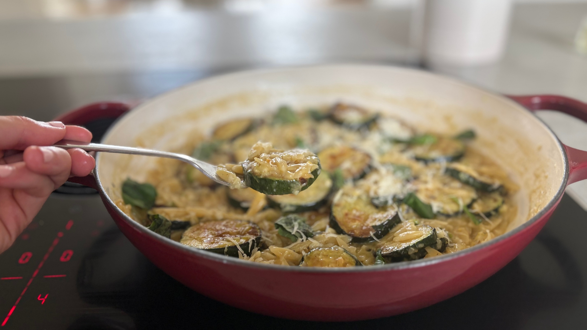 Making courgette orzo pasta in the Le Creuset Shallow Casserole Dish