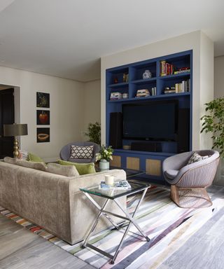 A blue bookshelf in front of a gray sofa