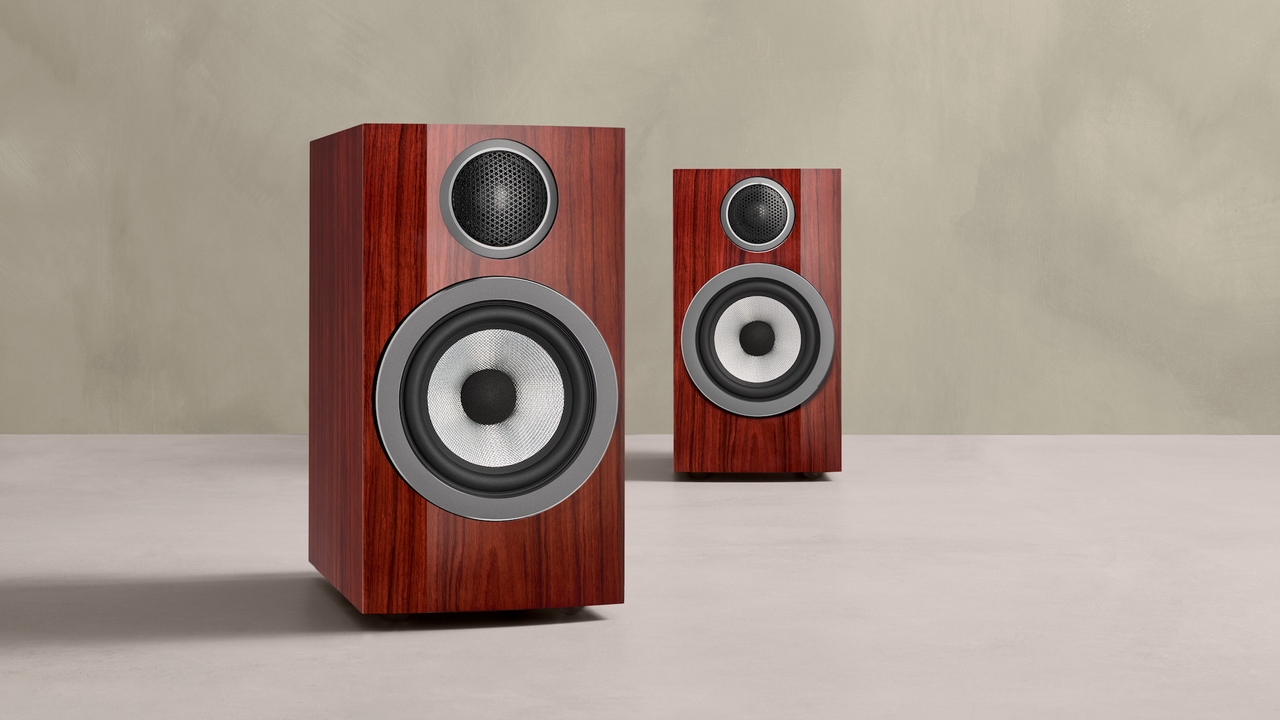 Product photo of the Bowers &amp; Wilkins 707 Prestige Edition with two speakers on a stone-coloured surface and a slightly darker background