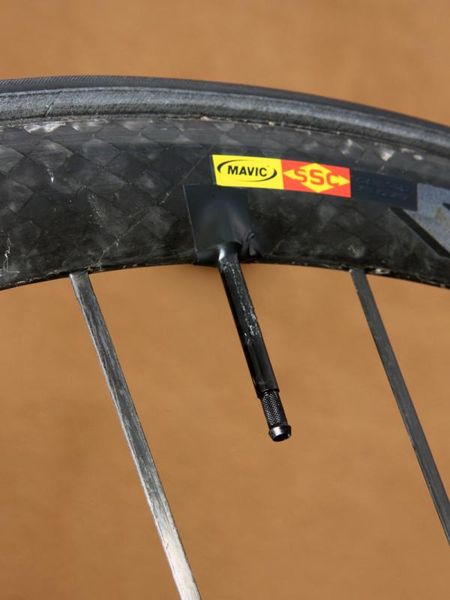 A strip of electrical tape keeps the valve extender from rattling during rides.