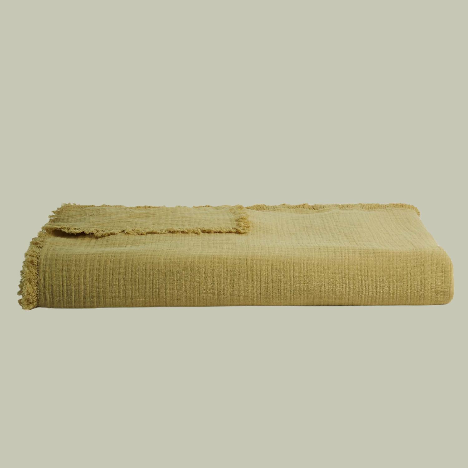 A muslin green throw