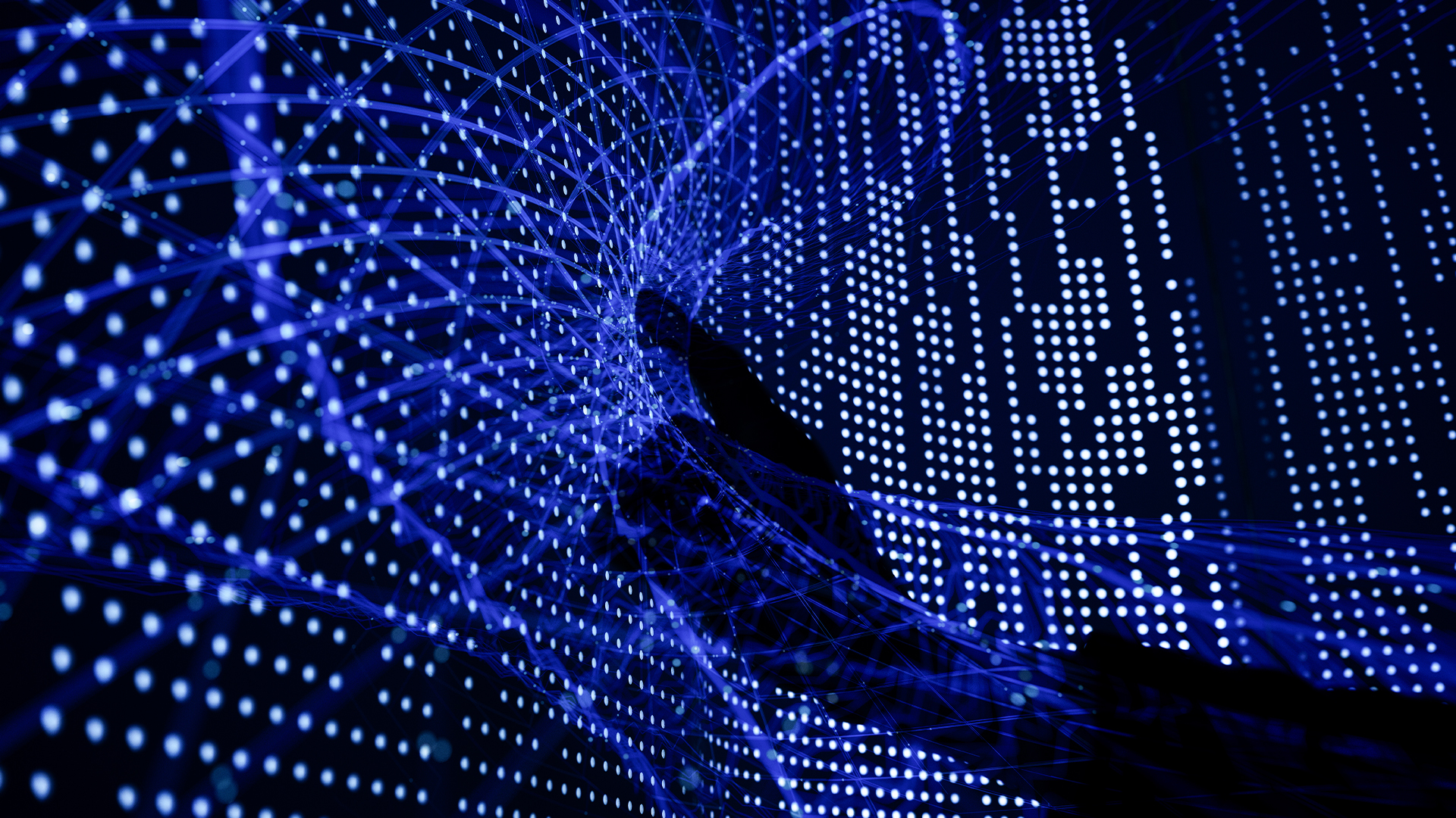 Digital transformation concept image showing human hand touching digital interface with glowing data points.