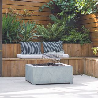 concrete firepit by built in corner seating