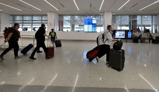 Travelers arrive at Los Angeles International Airport the week before Thanksgiving in Los Angeles.