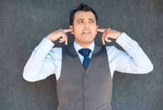 Man covering ears