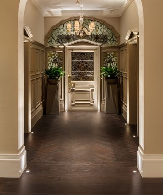 hallway with small flooring lights recessed into dark wooden floor