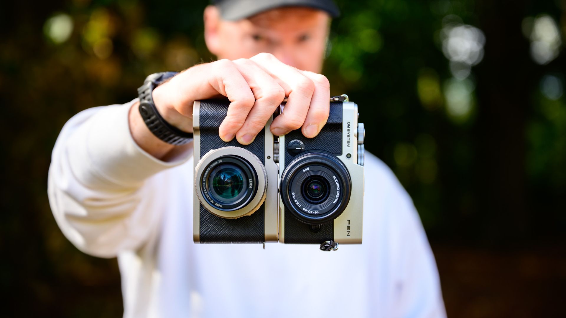 I compared the OM System PEN and Lumix L10 — which classy Micro Four Thirds model wins? 23 OM System PEN vs Panasonic Lumix L10: two micro four thirds cameras side by side in tech journalist Tim Coleman's hands, dappled tree light background