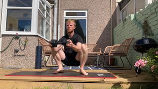 Fit&Well fitness writer Harry Bullmore performing the goblet squat stretch
