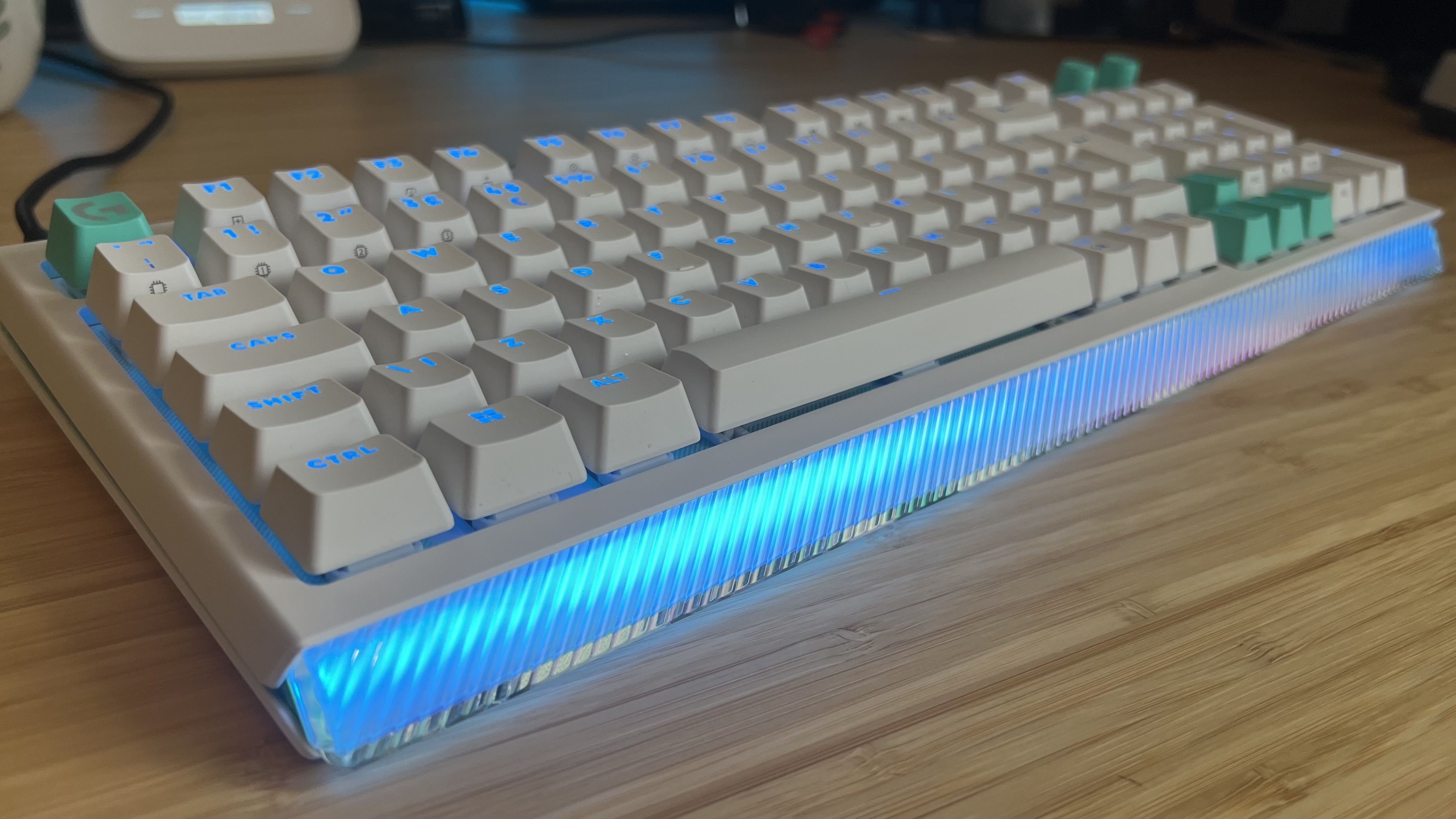 Logitech G512 X gaming keyboard with RGB light bar in the center of the frame