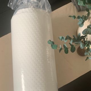 The Emma Foam pillow rolled up in bag