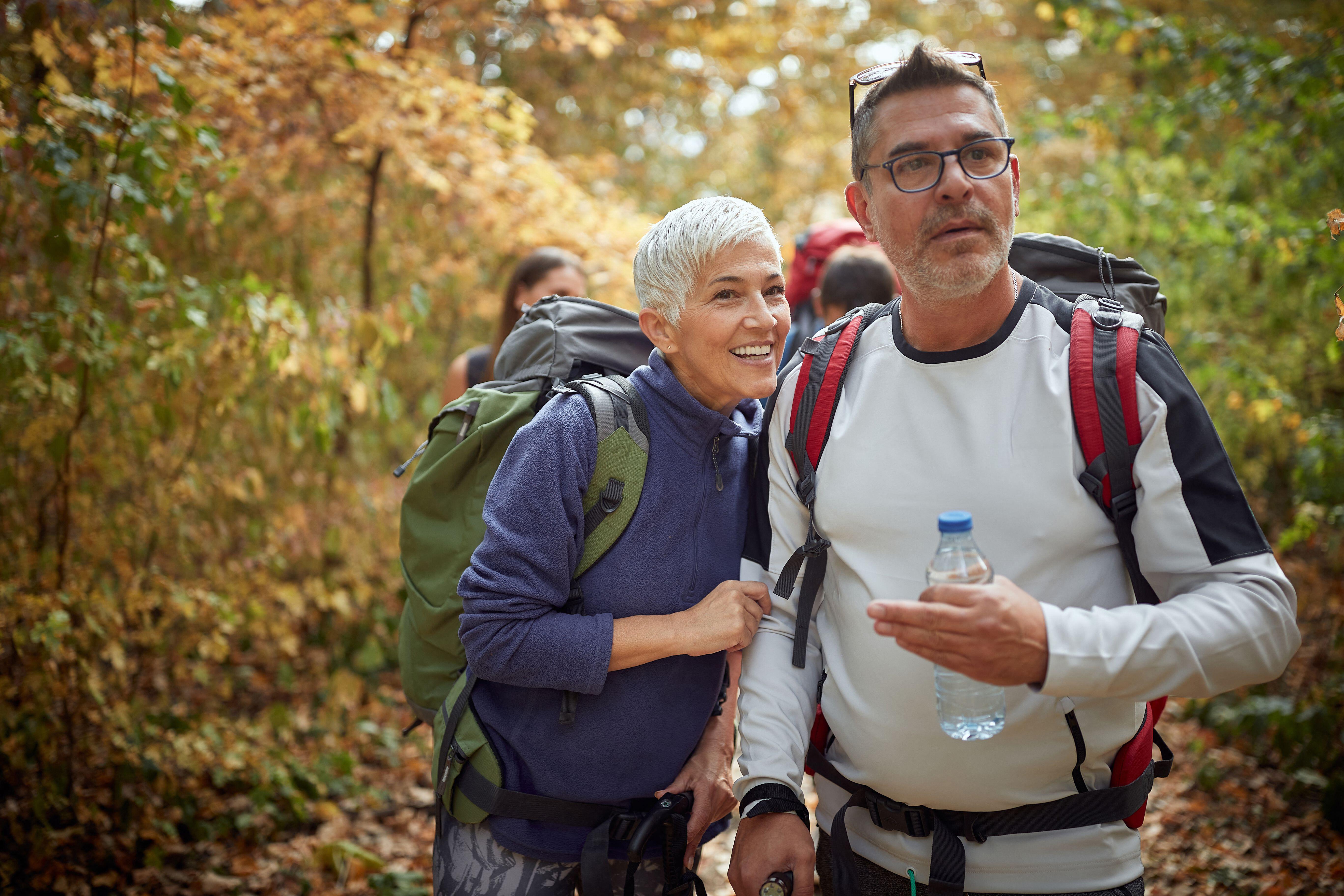 Senior couple trekking in the woods; Active retirement concept
