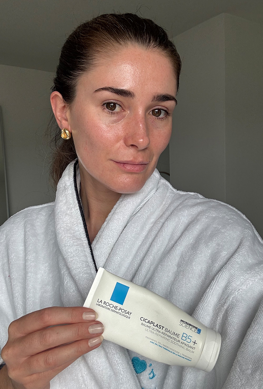 Beauty editor Eleanor after using Cicaplast, wearing white dressing gown and holding the product