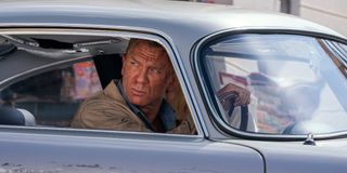 A bloodied James Bond drives a car in 'No Time To Die'