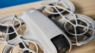 A gray DJI Neo drone with a camera