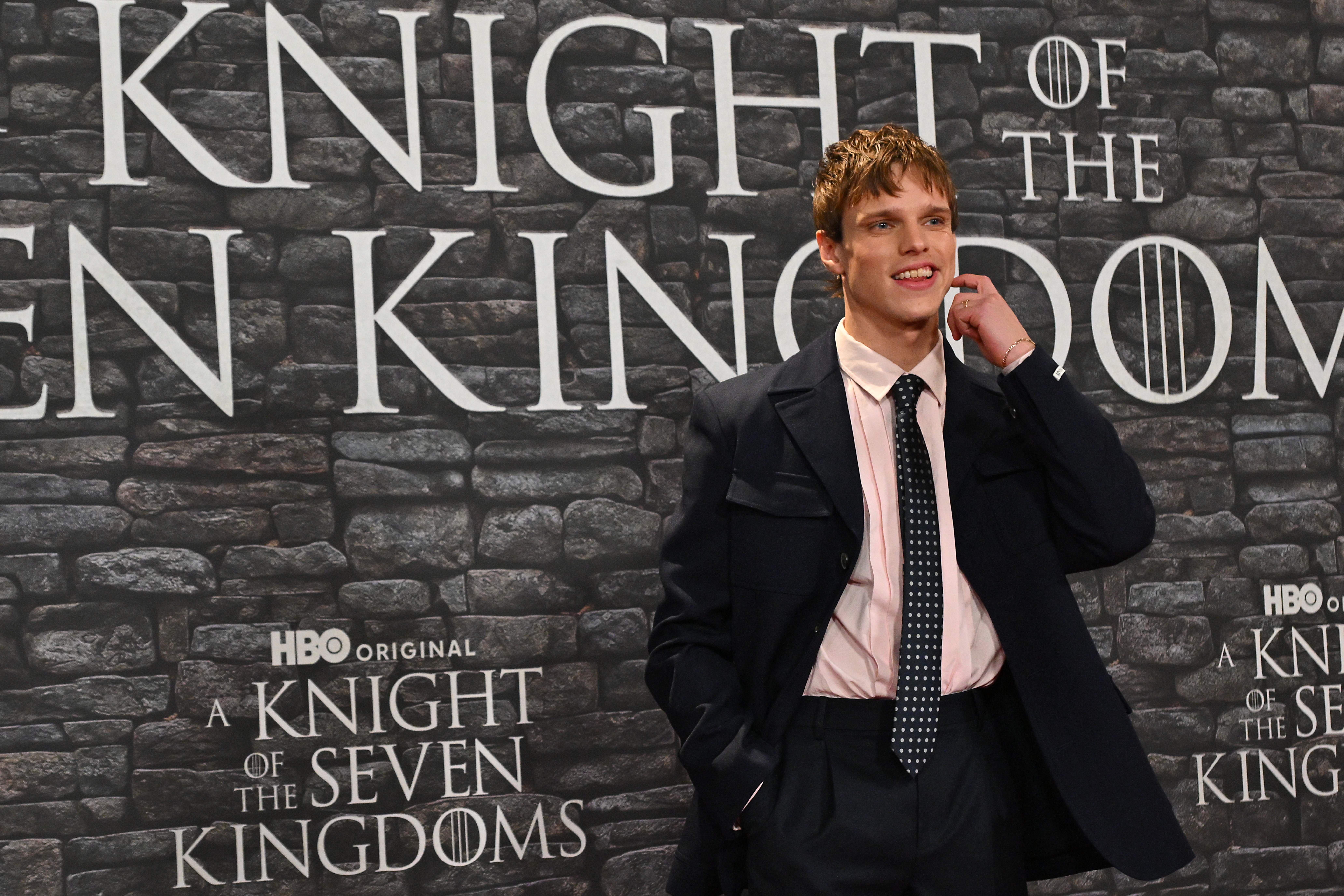 British actor Finn Bennett poses in a black suit pink shirt and polka dot tie as part of a red carpet event for the newly released hbo series A Knight of the Seven Kingdoms in Rome on January 15, 2026
