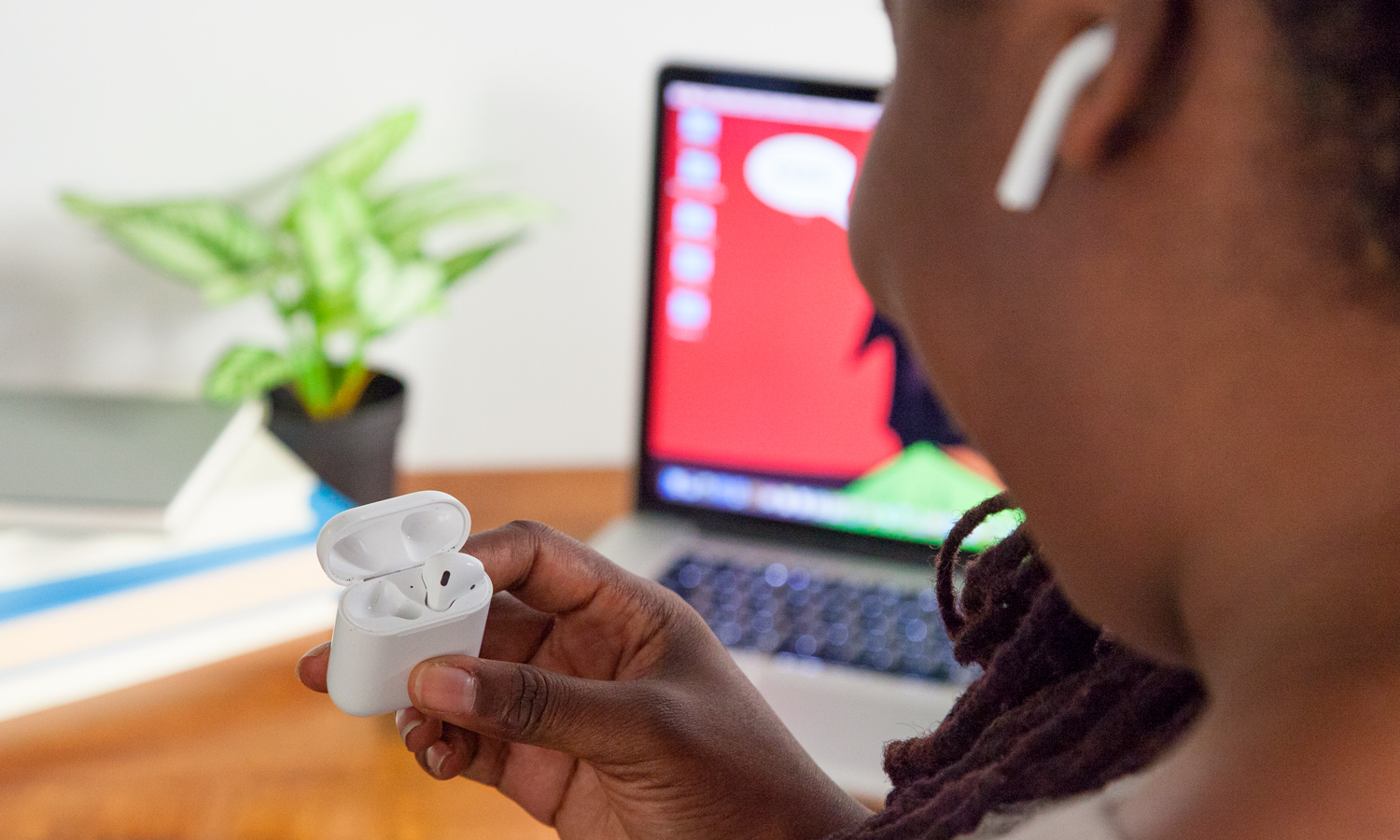 Holding AirPods in charging case. Image Credit: Shaun Lucas