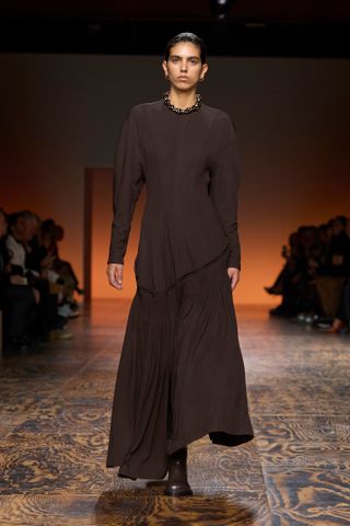 Photo of model walking in Mocha Mousse colorway in Bottega Veneta Fall-Winter 2024 show.