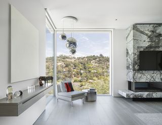 Bedroom with large window and amazing view and grey chair at Casltegate Residence