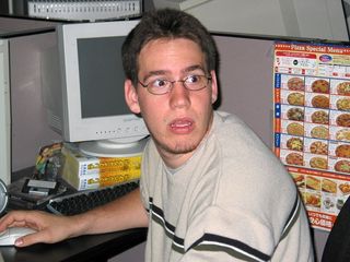 Young Brode working on the night crew in 2003. Note pizza menu pinned to cubicle wall.