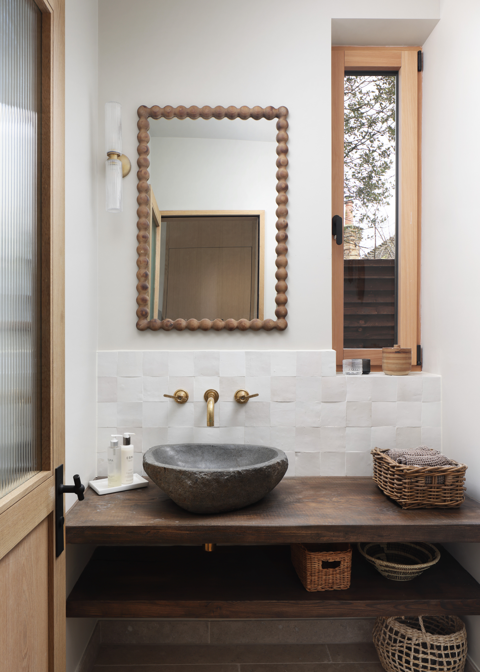 small bathroom with white zellige tiles and wooden countertops