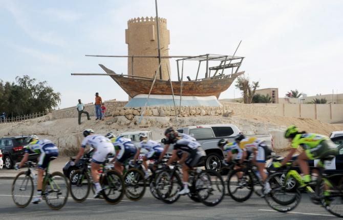 The peloton races by a local landmark