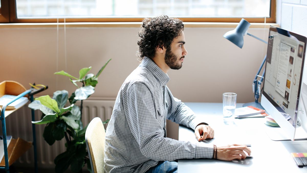 man working on computer at desk