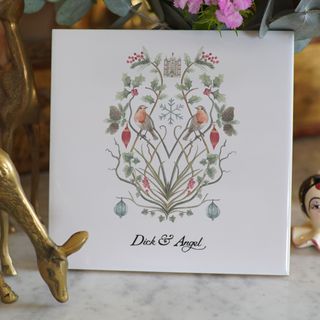 Joyeux Noel tile featuring traditional Christmas motifs – robins, red berries, holly and ivy, and Christmas baubles, personalised with Dick & Angel written on it