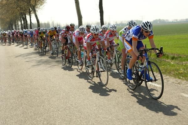 The bunch is strung out chasing the break.