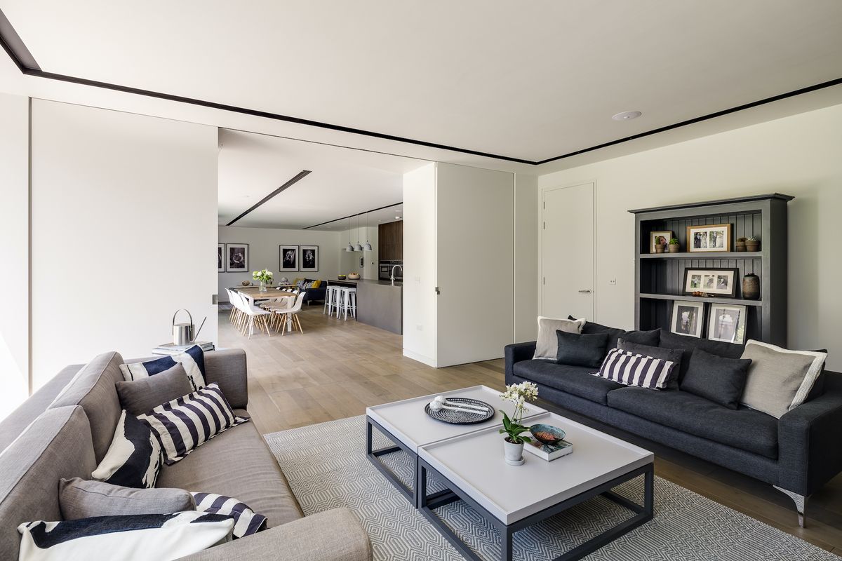 living room with track lighting and large pocket doors