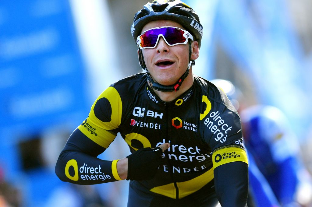 Stage winner Bryan Coquard points to the sponsor logo