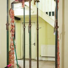 Knocking down walls during a renovation project. Acrow props support the structure during the process