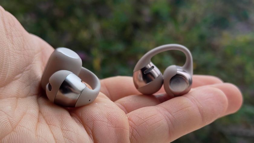 The Shokz OpenDots One in a man&#039;s hand.