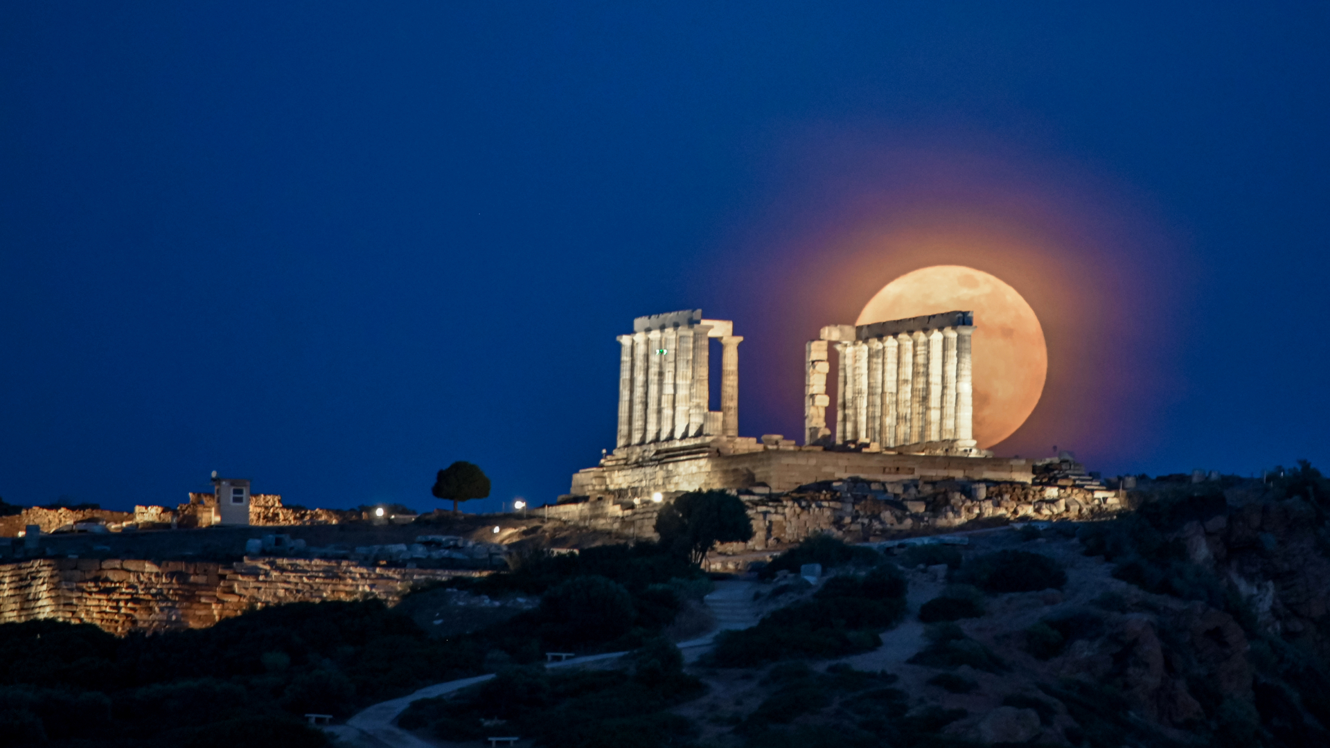 May&#039;s full &#039;Flower Moon&#039; can be seen rising behind the columns of the ruined Temple of Poseidon in southern Greece.