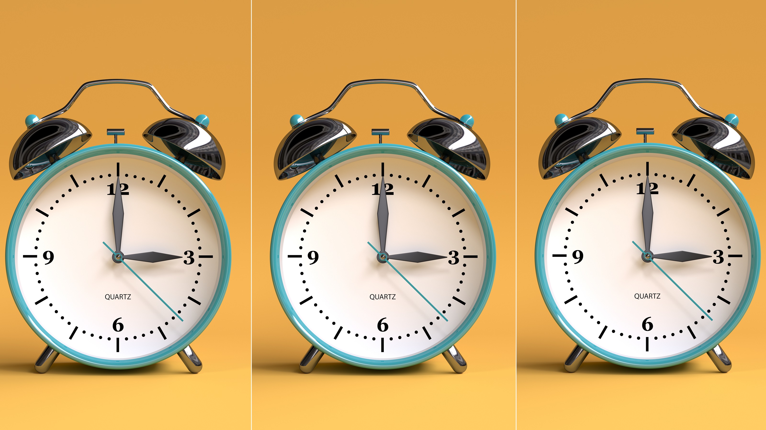 Three alarm clocks lined up against orangish background.