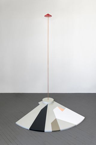 Abstract floor sculpture with tall antenna and red triangular top