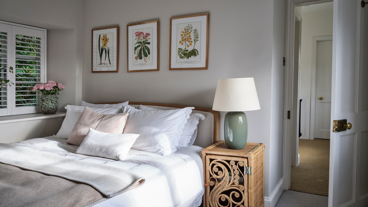 neural bedroom with pale pink and white cushions and blankets