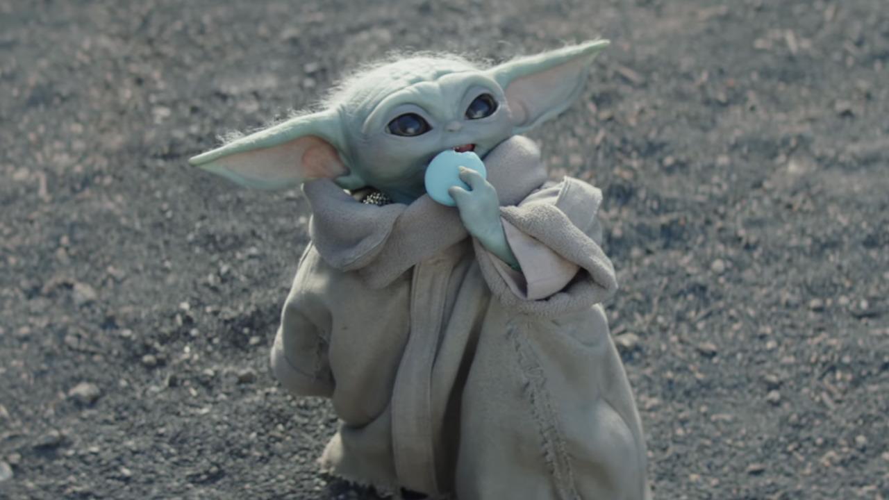 Grogu eating a blue macaron in The Mandalorian and Grogu