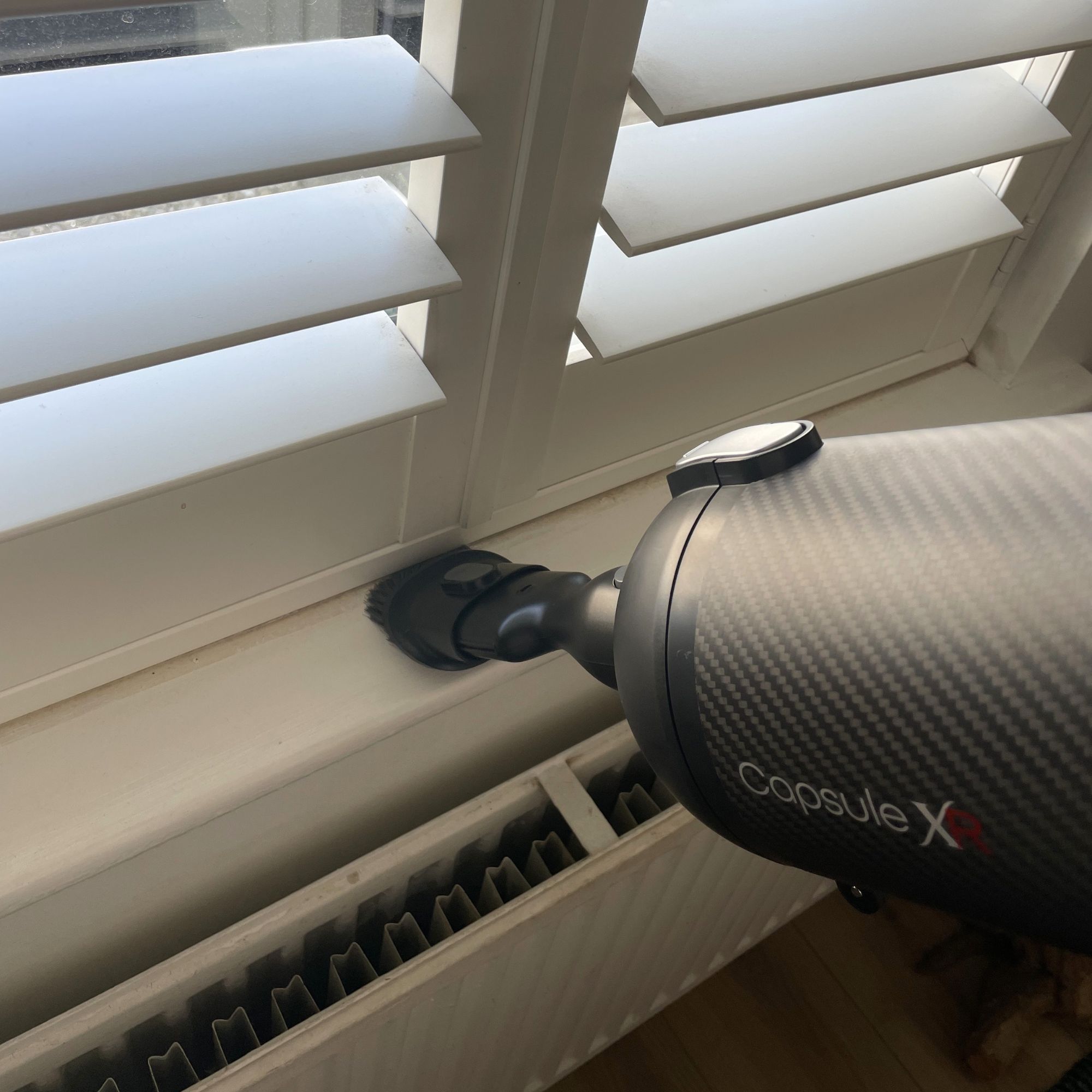 Using the Halo Capsule XR handheld to dust window sill