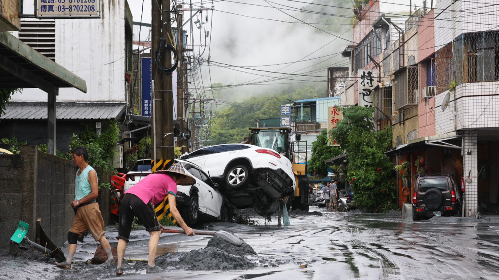 Residents shoveling mud