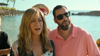 Aniston and Sandler on a beach in Murder Mystery 2
