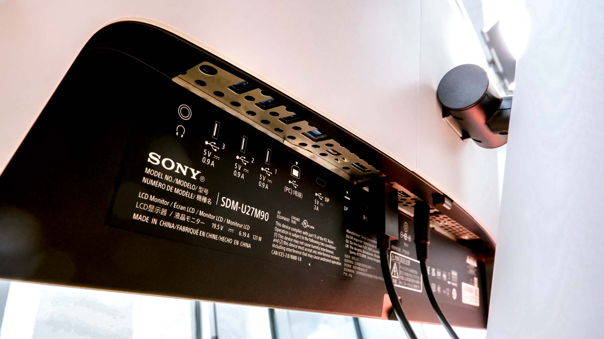 Sony Inzone M9 gaming monitor seen from the back, with a close-up view of the ports