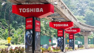 Three Toshiba signs displayed under an overpass in Kuala Lumpur