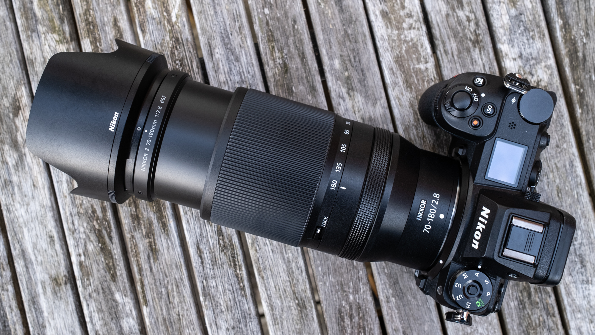 Nikkor Z 70-180mm f/2.8 attached to a Nikon Z 7II on a wooden outdoor table