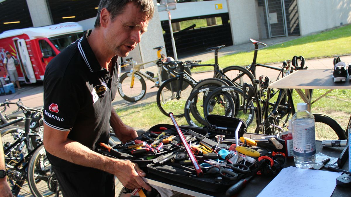 MTN Qhubeka mechanic Stef van Zundert consults his notes on rider specs while assembling bikes