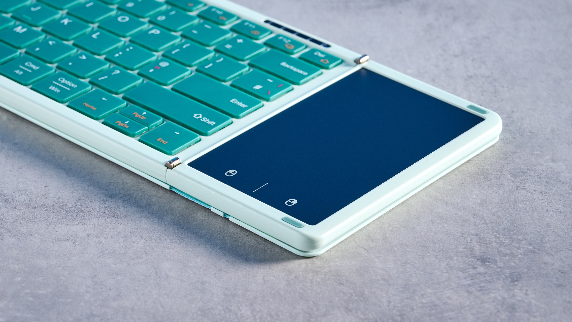 Seenda Foldable Bluetooth Keyboard with Touchpad pictured in front of a blue background.