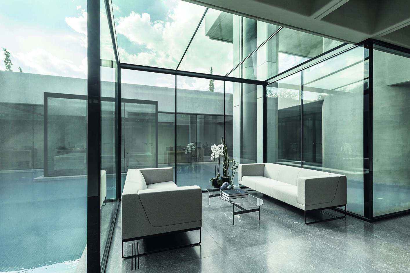 Greek brutalist gem AGET Iraklis by Alexandros Tombazis redesigned by Georges Batzios, clean concrete and marble and stone surfaces and shapes