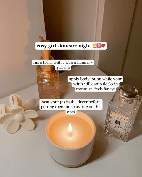 A beside table with a candle, perfume, and a flower hair clip, with information about 'cosy girl skincare'