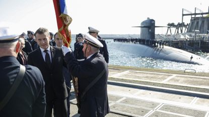 France's President Emmanuel Macron greets French Navy members upon his arrival to visit to the Nuclear Submarine Navy Base of Ile Longue in Crozon, north-western France