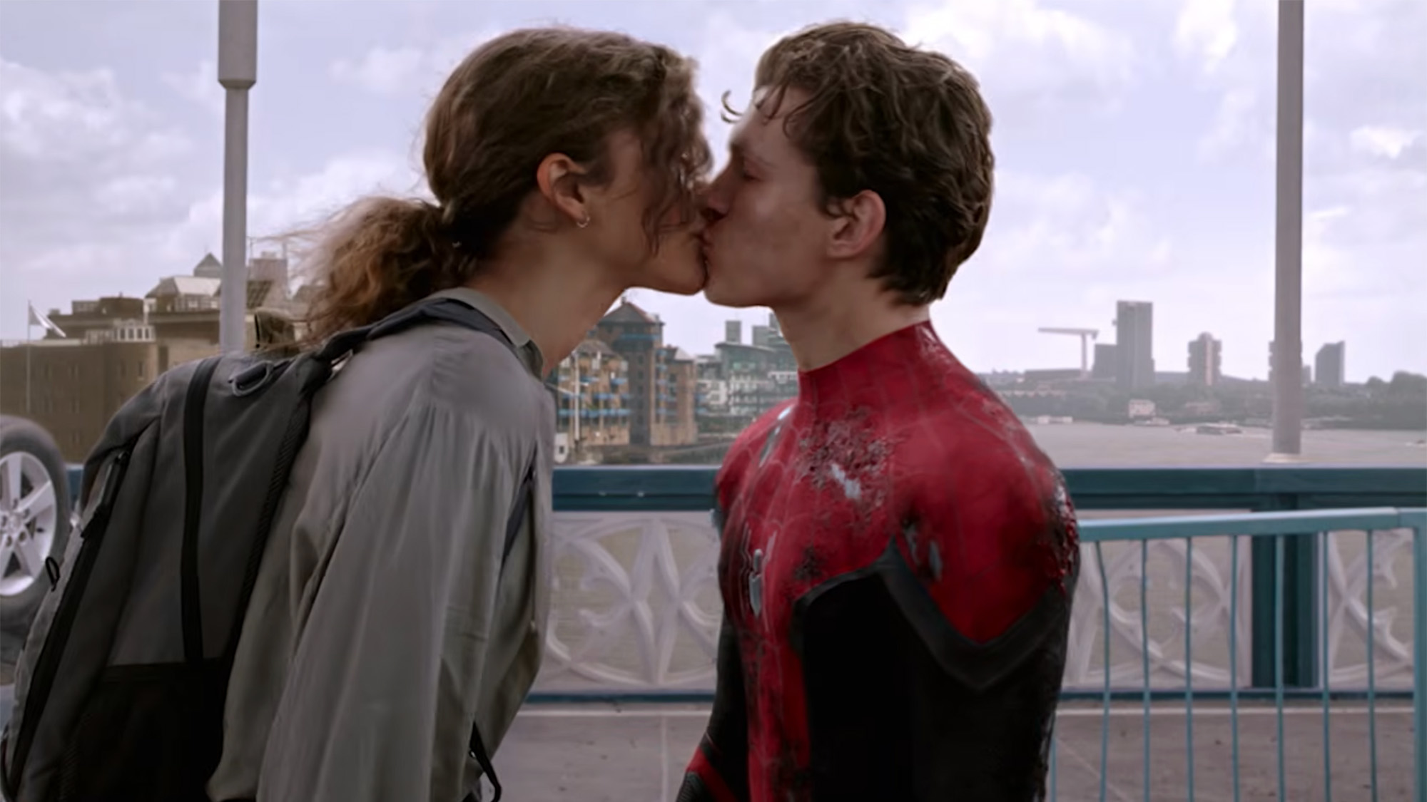 Zendaya as MJ and Tom Holland as Peter Parker smooch for the first time on a bridge in Spider-Man.