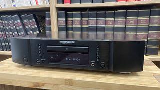 Marantz CD6007 in black finish on wooden rack with magazines in background